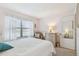 Bedroom with a double bed, dresser, and armchair near window at 635 30Th Ave W # F206, Bradenton, FL 34205