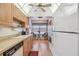 Condo kitchen with white appliances and wood cabinets at 635 30Th Ave W # F206, Bradenton, FL 34205