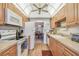 Bright condo kitchen with white appliances and wood cabinets at 635 30Th Ave W # F206, Bradenton, FL 34205