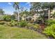 Lush landscaping around a pond and condo building with a small waterfall at 635 30Th Ave W # F206, Bradenton, FL 34205