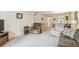 Spacious living room with two recliners and view to dining area at 635 30Th Ave W # F206, Bradenton, FL 34205