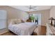 Bedroom with white bedding, wooden floors, and sliding glass doors to patio at 6549 Waterford Cir, Sarasota, FL 34238