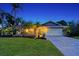 Charming single story home with landscaped yard at dusk at 6549 Waterford Cir, Sarasota, FL 34238