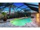 Inviting screened pool and patio area with travertine tile at 6549 Waterford Cir, Sarasota, FL 34238