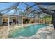 Relaxing freeform pool with screened enclosure at 6549 Waterford Cir, Sarasota, FL 34238