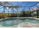 Inviting screened pool with stone deck at 6549 Waterford Cir, Sarasota, FL 34238