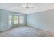 Bright bedroom featuring a bay window and ceiling fan at 6723 Approach Rd # 35, Sarasota, FL 34238