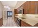 Updated kitchen boasting wood cabinets, quartz countertops, and stainless steel appliances at 6723 Approach Rd # 35, Sarasota, FL 34238