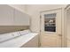Laundry room with washer, dryer, cabinets and exterior access at 6723 Approach Rd # 35, Sarasota, FL 34238