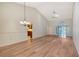 Open living room with hardwood floors, high ceilings, and access to a sunroom at 6723 Approach Rd # 35, Sarasota, FL 34238