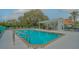 Community pool with covered patio and lounge chairs at 6723 Approach Rd # 35, Sarasota, FL 34238