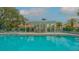 Community pool with covered seating area at 6723 Approach Rd # 35, Sarasota, FL 34238