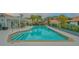 Community pool with a covered patio and lounge chairs at 6723 Approach Rd # 35, Sarasota, FL 34238