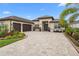 Attractive two-story home with a three-car garage and landscaped yard at 7139 Tamworth Pkwy, Sarasota, FL 34241