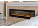 Modern linear electric fireplace with stone surround at 7139 Tamworth Pkwy, Sarasota, FL 34241