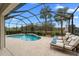Relaxing screened-in pool and patio area with lounge chairs at 7139 Tamworth Pkwy, Sarasota, FL 34241