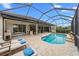 Inviting pool and patio area with covered lanai, lounge chairs, and outdoor kitchen at 7139 Tamworth Pkwy, Sarasota, FL 34241