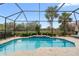 Relaxing screened-in pool with fountain and lush landscaping at 7139 Tamworth Pkwy, Sarasota, FL 34241