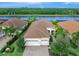 Single-Gathering home with two-car garage, situated on a lake with lush landscaping at 7220 Whittlebury Trl, Lakewood Ranch, FL 34202