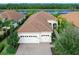 Single-Gathering home with two-car garage and a landscaped front yard at 7220 Whittlebury Trl, Lakewood Ranch, FL 34202