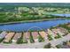 Aerial view of home near golf course and lake at 7220 Whittlebury Trl, Lakewood Ranch, FL 34202