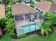 Aerial view of a house with a private pool and screened enclosure at 7220 Whittlebury Trl, Lakewood Ranch, FL 34202