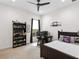 bedroom with twin bed, desk, and built-in shelving at 7220 Whittlebury Trl, Lakewood Ranch, FL 34202