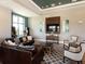 Relaxing clubhouse lounge with leather sofas and large TV at 7220 Whittlebury Trl, Lakewood Ranch, FL 34202