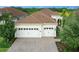 Two-car garage and front yard landscaping at 7220 Whittlebury Trl, Lakewood Ranch, FL 34202