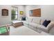 Spacious Gathering room with sectional sofa and large American flag art at 7220 Whittlebury Trl, Lakewood Ranch, FL 34202