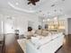 Open concept living room and kitchen with hardwood floors and neutral decor at 7220 Whittlebury Trl, Lakewood Ranch, FL 34202