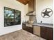 Stainless steel appliances and granite countertops feature in this outdoor kitchen at 7220 Whittlebury Trl, Lakewood Ranch, FL 34202