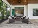 Cozy outdoor patio with fire pit and seating, leading to the interior at 7220 Whittlebury Trl, Lakewood Ranch, FL 34202