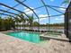 Inviting screened pool with spa and lake view at 7220 Whittlebury Trl, Lakewood Ranch, FL 34202