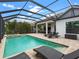 Screened pool with outdoor kitchen and lounge at 7220 Whittlebury Trl, Lakewood Ranch, FL 34202