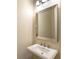 Small powder room with a pedestal sink and large mirror at 7220 Whittlebury Trl, Lakewood Ranch, FL 34202