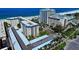 Aerial view of condo community near beach, featuring multiple buildings and parking at 800 Benjamin Franklin Dr # 202, Sarasota, FL 34236
