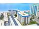 Aerial view of beachfront condo building with parking and pool at 800 Benjamin Franklin Dr # 202, Sarasota, FL 34236