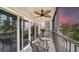 Relaxing screened balcony with outdoor seating and sunset view at 800 Benjamin Franklin Dr # 202, Sarasota, FL 34236