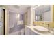 Updated bathroom with walk-in shower and modern vanity at 800 Benjamin Franklin Dr # 202, Sarasota, FL 34236