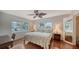 King-size bed, ceiling fan, and ample natural light at 800 Benjamin Franklin Dr # 202, Sarasota, FL 34236