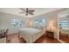 King-size bed, ceiling fan, and hardwood floors at 800 Benjamin Franklin Dr # 202, Sarasota, FL 34236