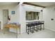 Community kitchen with bar seating and appliances at 800 Benjamin Franklin Dr # 202, Sarasota, FL 34236
