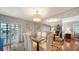 Elegant dining area with glass table and seating for six at 800 Benjamin Franklin Dr # 202, Sarasota, FL 34236