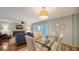 Dining area with glass-top table and comfortable seating for four at 800 Benjamin Franklin Dr # 202, Sarasota, FL 34236