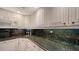 Well-equipped kitchen with ample counter space and white cabinetry at 800 Benjamin Franklin Dr # 202, Sarasota, FL 34236