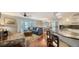 Open living room with hardwood floors, comfy seating, and kitchen access at 800 Benjamin Franklin Dr # 202, Sarasota, FL 34236