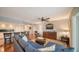 Open living area with hardwood floors, sectional sofa, and large TV at 800 Benjamin Franklin Dr # 202, Sarasota, FL 34236