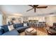 Spacious living room with hardwood floors, sectional sofa, and kitchen views at 800 Benjamin Franklin Dr # 202, Sarasota, FL 34236
