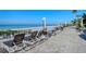 Oceanfront patio with chairs and tables for relaxation at 800 Benjamin Franklin Dr # 202, Sarasota, FL 34236